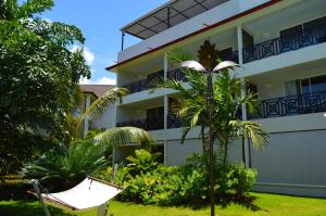 an empty hammock in front of a building at Savoy Hotel Boutique in Las Terrenas