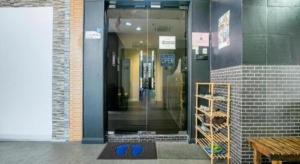 a door to a store with blue shoes in it at SPOT ON 89726 Capsule Inn in Kota Kinabalu +108 photos