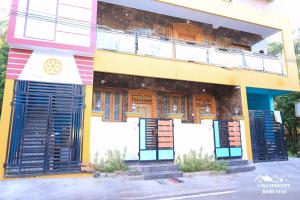 a colorful building with doors and a balcony at Spacious Family Space Near Serenity Beach in Puducherry +2 photos