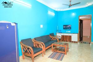a living room with blue walls and a couch and chairs at Spacious Family Space Near Serenity Beach in Puducherry