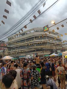 a crowd of people standing in front of a building at RoXx Social Hostel in Bangkok