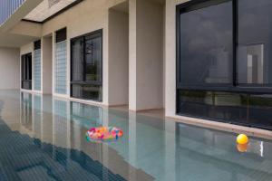 a swimming pool with a beach ball in the water at Scarlatta in Ghoti Budrukh