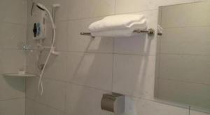 a white phone on a wall in a bathroom at Hotel Pangkor Mutiara in Pangkor