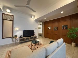 a living room with a couch and a tv at BohoHaven 半独立别墅 Semi D 5R 3B 15mins to KK City in Kota Kinabalu