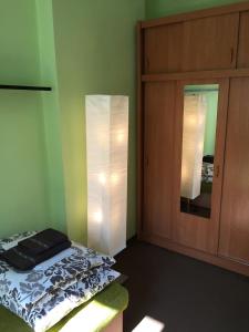 a bedroom with a bed and a cabinet and a mirror at Mieszkanie na Starym Mieście in Olsztyn