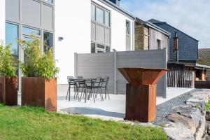 a patio with chairs and tables in front of a building at La laiterie de Claire in Bouillon