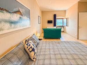 a living room with a couch and a green chair at La Suite del Faro - HelloElba in Portoferraio