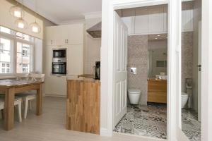 a kitchen with a table and a counter in a room at Mariacka Apartments in Gdańsk