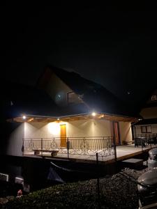 a house with a balcony at night with lights at Domek Zakopane Folk Chalet in Zakopane