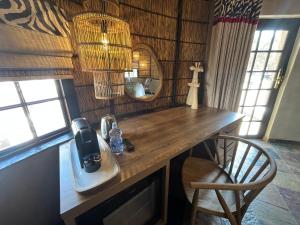 a kitchen counter with a hair dryer and a mirror at Kievits Kroon Gauteng Wine Estate in Pretoria