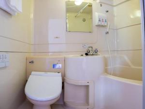 a bathroom with a toilet and a sink and a tub at Tabist Hotel New Osamura Sabae in Fukui +72 photos