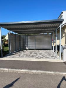 a large metal garage with a large driveway at Ferienwohnung in Ansbach-Elpersdorf in Ansbach