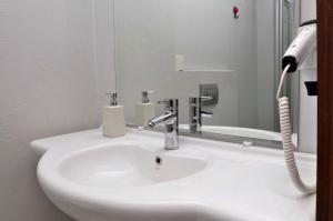 a bathroom with a white sink and a mirror at Paperon Butik Otel in Erdemli +32 photos