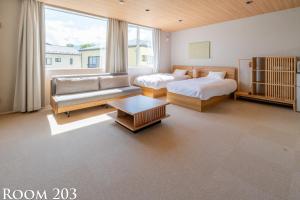 Giường trong phòng chung tại Ginkgo House ギンコハウス