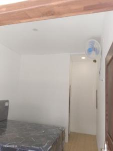 a room with a white wall and a ceiling at Omahe Petruk in Borobudur