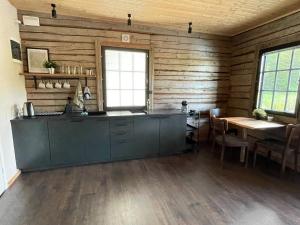 a kitchen with a counter and a table in a room at Loghouse by the lake in Viljandi +6 photos