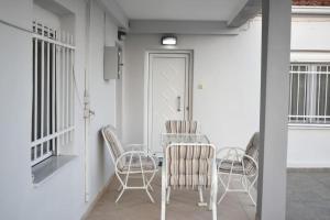 a dining room with chairs and a table at Avli Guesthouse 