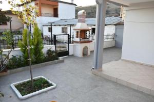 a courtyard of a house with a small tree at Avli Guesthouse 