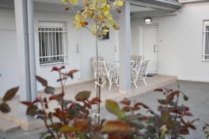 a patio with chairs and a table in a building at Avli Guesthouse  +10 photos