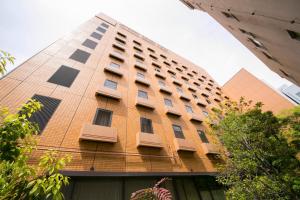 a tall brick building with windows on the side of it at Princess Garden Hotel in Nagoya