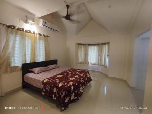 a bedroom with a bed in the middle of it at Varsha's Nest at Uthandi in Chennai