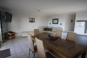 a living room with a wooden table and chairs at 3-36 Manooka Drive - Rainbow Beach - Sea Views and breezes in Rainbow Beach