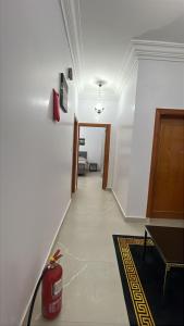 a hallway leading to a room with a fire hydrant at شقة راقية للايجار اليومي in Taif +1 photo