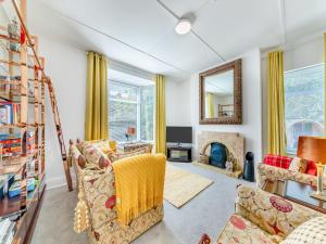 a living room with a couch and a fireplace at The Manse in Coxhoe