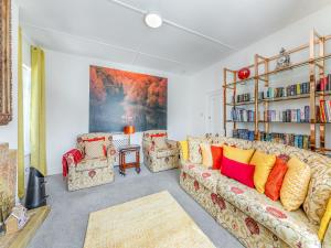 a living room with a couch and a book shelf at The Manse in Coxhoe