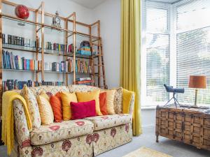 a living room with a couch with colorful pillows at The Manse in Coxhoe +18 photos