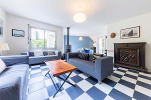 a living room with two couches and a fireplace at Family vacation home 100 m from beach - Ty For Tous in Île-Tudy