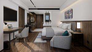 a hotel room with a bed and a desk and a desk at Oakwood Yogyakarta in Jetis