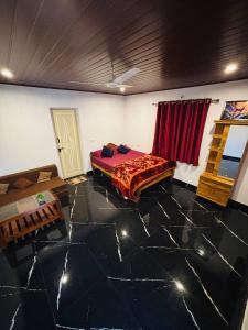 a room with a bed in a room with marble floors at Coorg Sunrise Cottage Homestay in Kushālnagar +22 photos