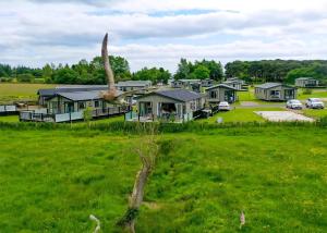 a group of houses in a field of green grass at Heathergate Boutique Holiday Park in Hexham