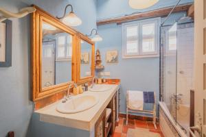 a bathroom with two sinks and a shower at La Casa Del Herrero - Requijada in Requijada +28 photos