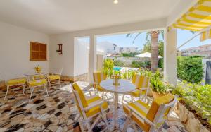 a patio with a table and chairs and a pool at Villa Antonio in Can Pastilla