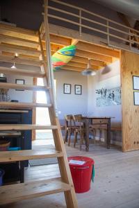 a loft bed in a room with a dining room at Pioka Loft Art & Surf in Plouharnel +31 photos