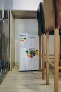 a white refrigerator with a picture of fruit on it at 7 Nebo in Almaty