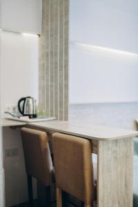 a kitchen with a wooden table with chairs at 7 Nebo in Almaty