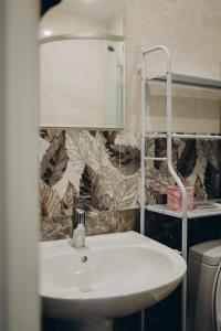 a bathroom with a white sink and a lamp at 7 Nebo in Almaty