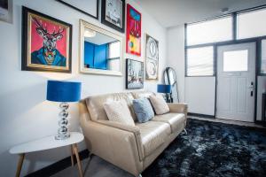 a living room with a couch and a blue lamp at The Luxury Canvas by The Hive WA1 in Warrington +12 photos