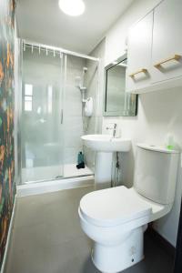 a bathroom with a toilet and a sink and a shower at The Luxury Canvas by The Hive WA1 in Warrington
