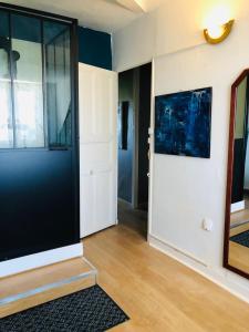 un salon avec une grande porte et un couloir dans l'établissement Appartement - LES COMBLES DU CHATEAU DES MARAIS - Avec vue sur le lac - POUR 2 à 5 PERSONNES, à Saint-Philbert-de-Grand-Lieu 14 autres photos