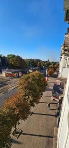 a person walking down a sidewalk next to a building at Wood Appartment on Svobody in Kamianske