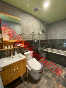 a bathroom with a white toilet and a sink at Starry Night in Taitung City +45 photos