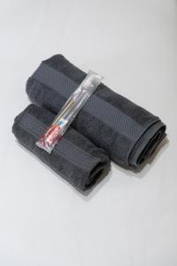 a pile of black towels on a white background at Spacious 2br Near Queens Uni & City Centre in Belfast