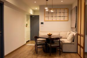 a living room with a table and a couch at Premium Hulhumale Sanctuary - 2BR Beach View Apartment in Male City