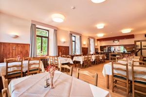 a dining room with white tables and chairs at Hotel Beau Site in Francorchamps