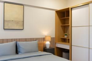 a bedroom with a bed and a book shelf at Premium Hulhumale Sanctuary - 2BR Beach View Apartment in Male City