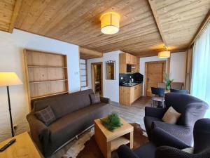a living room with a couch and a table at Apartment ALFA with jacuzzi in Demanovska Dolina